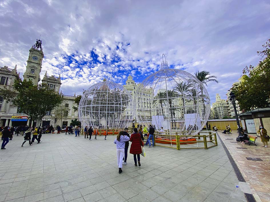 Christmas season in Valencia. 2 giant balls in white in the square with people